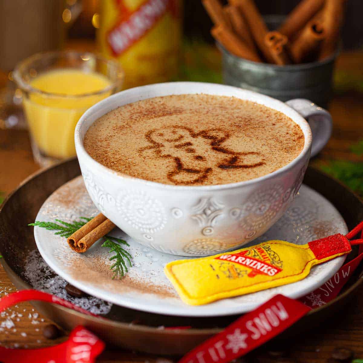 A latte coffee with advocaat with a gingerbread man stencilled on top.