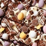 Close up of chocolate brownies with white chocolate and mini egg garnish.