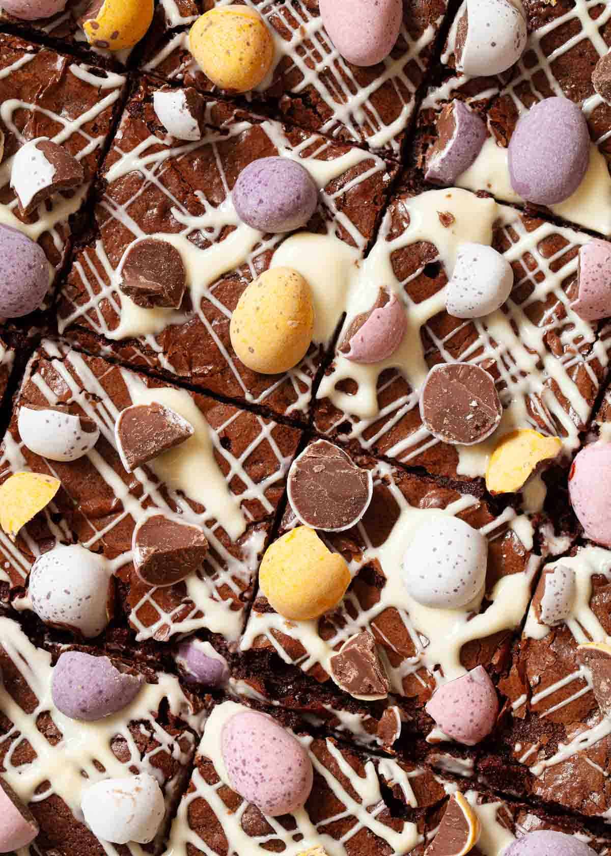 Easter Egg brownies drizzled in white chocolate and topped with Cadbury eggs.