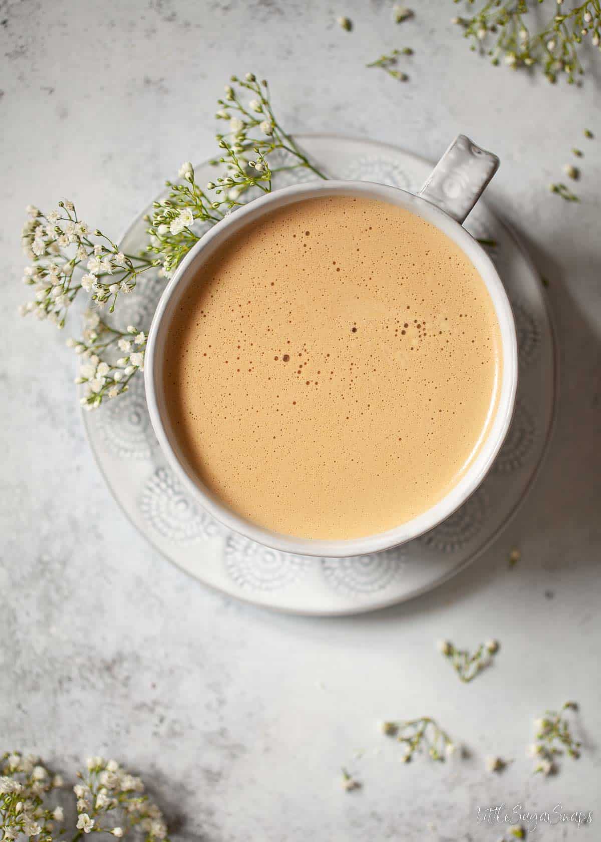 Overhead view of honey latte in a wide cup.