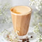 Close-up image of a glass oh oatmilk honey latte.