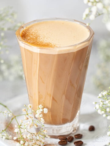 Close-up image of a glass oh oatmilk honey latte.
