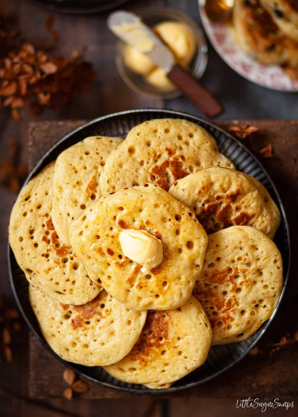 A plate of English pikelets (freeform crumpets).