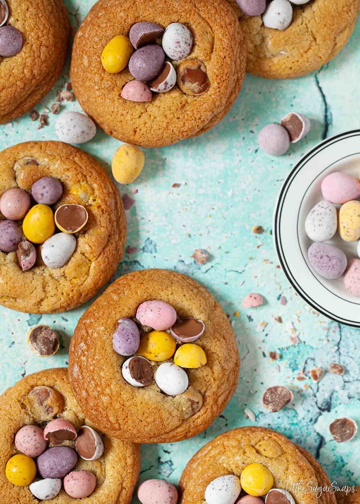 Cookies topped with Mini Eggs and a bowl of Mini Eggs alongside.