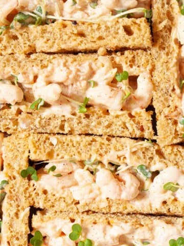 Close-up of prawn mayo finger sandwiches for afternoon tea.