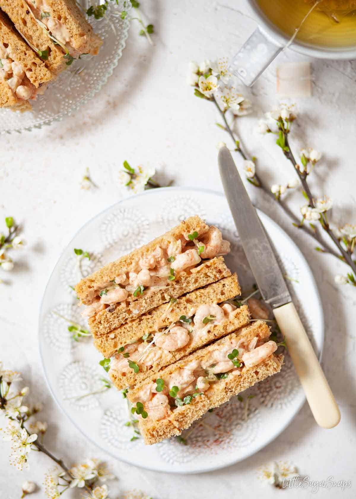 Prawn finger sandwiches on a plate.