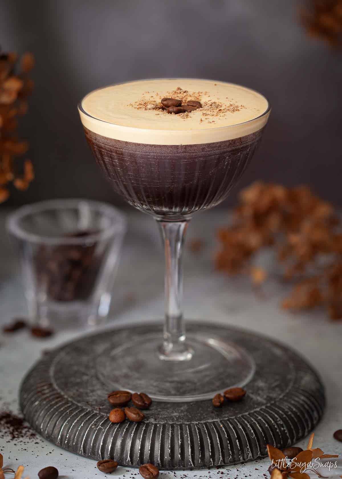 A rum coffee cocktail topped with grated chocolate and coffee beans.