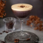 Close up of an espresso martini with rum topped with grated chocolate and coffee beans.