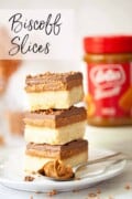A stack of Biscoff caramel slices with a jar of Biscoff spread in the background and text