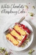 A labelled image of a plated slice of white chocolate sponge cake with raspberries.