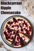 Labelled image of a fruit ripple cheesecake with several slices cut from it.