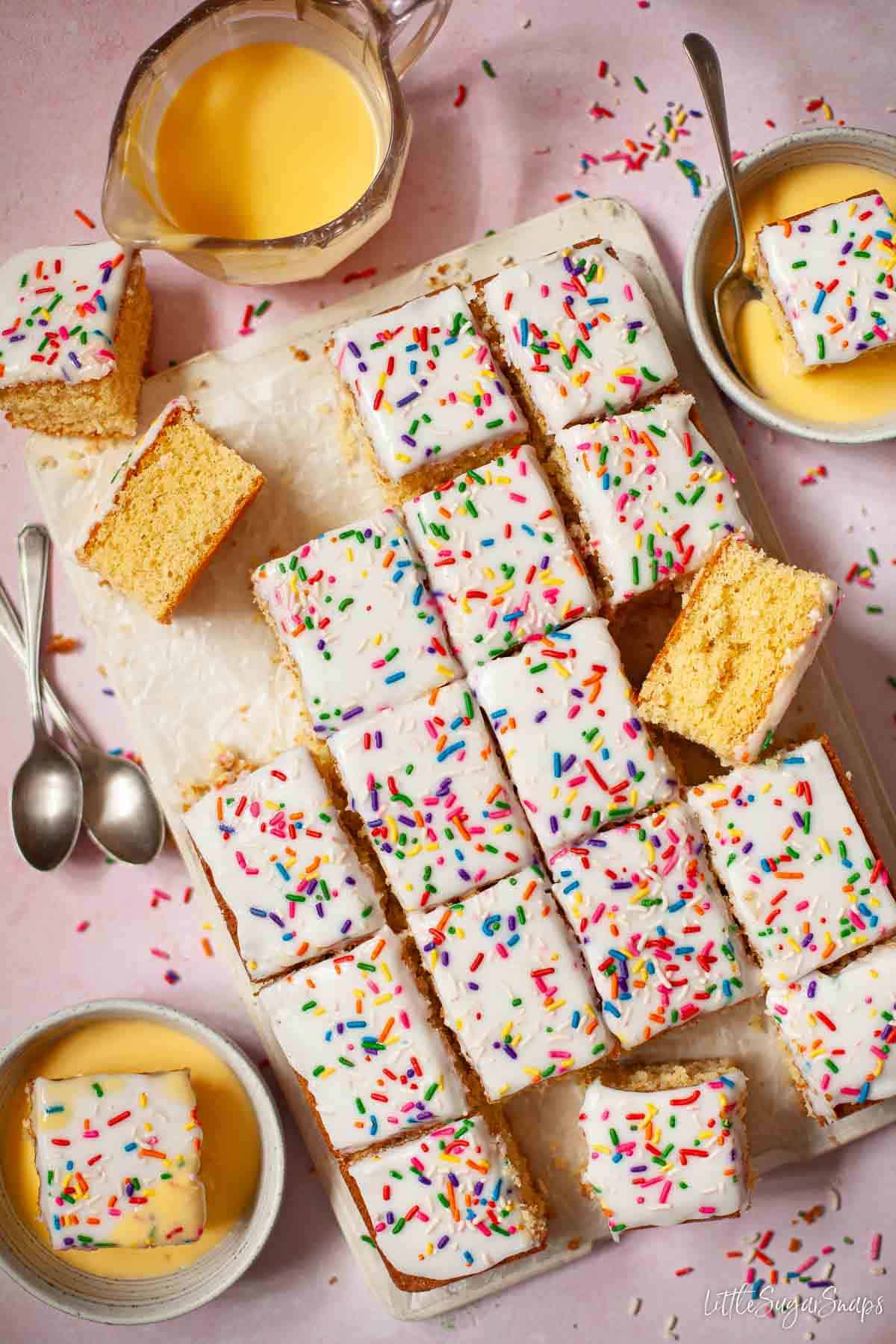 Cut up old school sponge cake with water icing, sprinkles and custard.