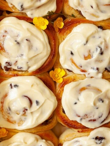 Close up of lemon curd rolls with lemon cream cheese frosting.