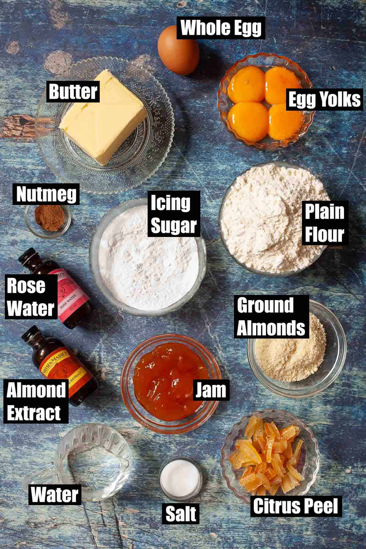 Labelled ingredients for a dessert made with jam, almonds, and citrus peel.