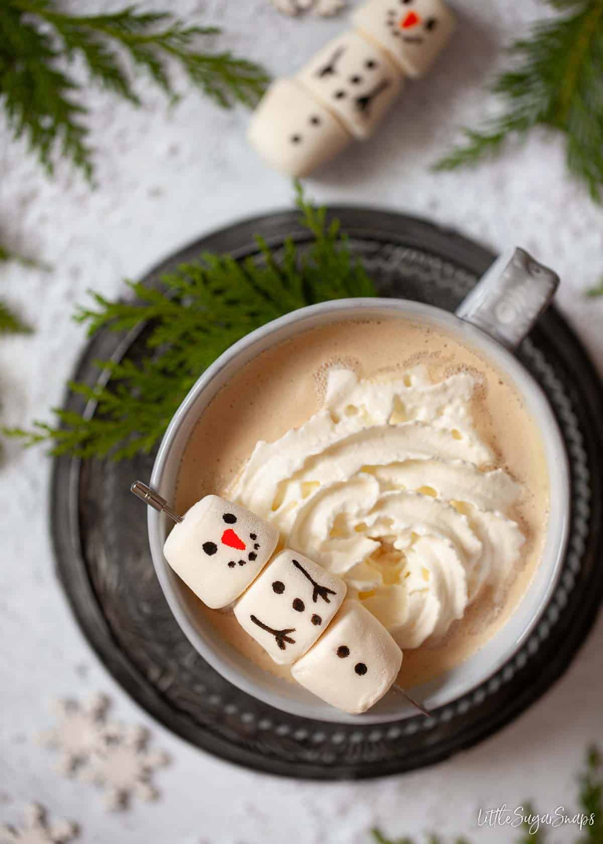 White chocolate mocha topped with whipped creamand a marshmallow snowman.