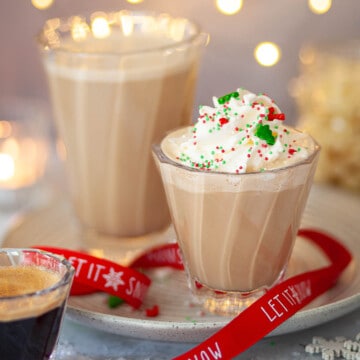 Two glasses of minty mocha drinks. One has whipped cream and sprinkles on top.