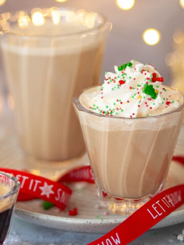 Two glasses of minty mocha drinks. One has whipped cream and sprinkles on top.