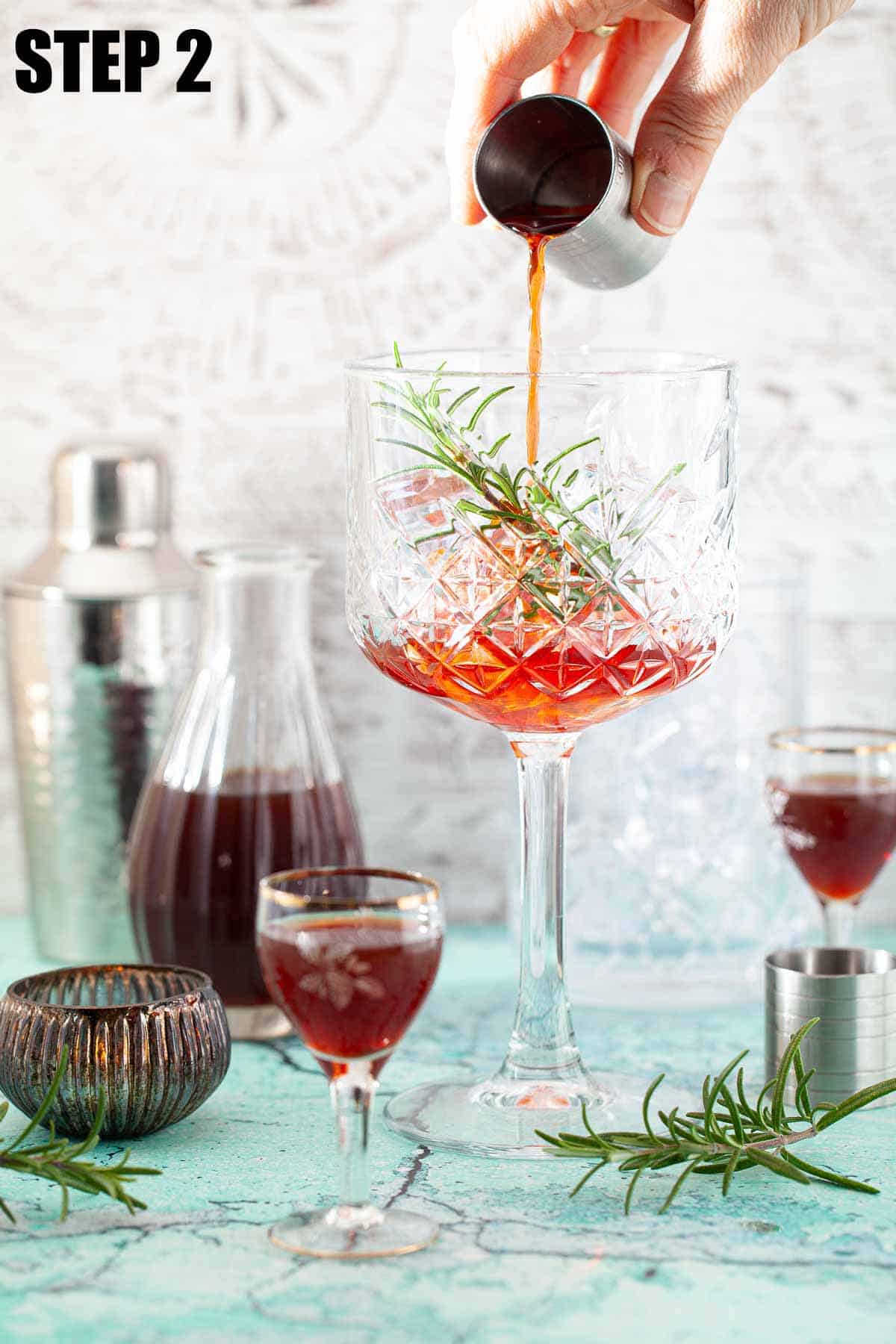 Alcohol being poured into a glass over ice.