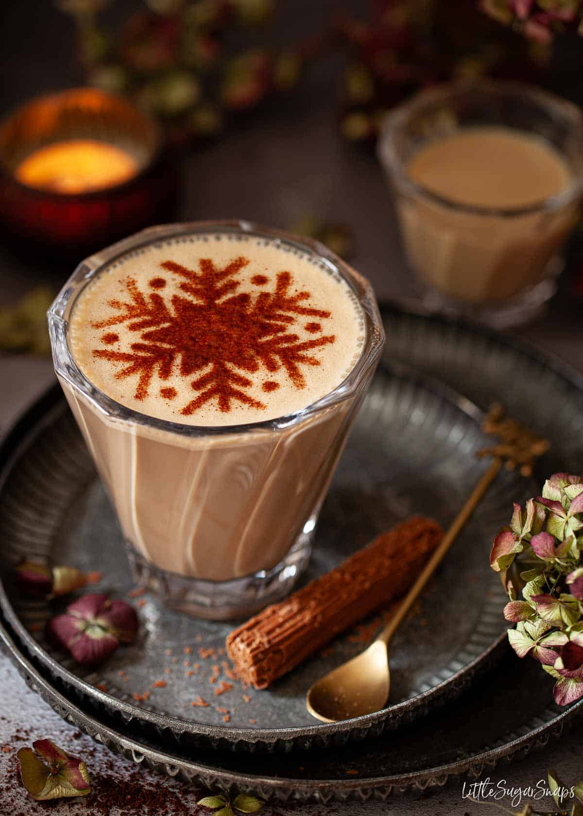 A creamy Baileys latte drink topped with a stencilled snowflake.