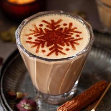 Close up of a Baileys latte decorated with a stencilled snowflake.