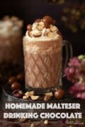 Labelled image of malted hot chocolate with whipped cream and crushed honeycomb chocolate garnish.