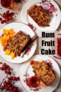 Three slices of rum fruit cake and cheese on plates with text overlay.