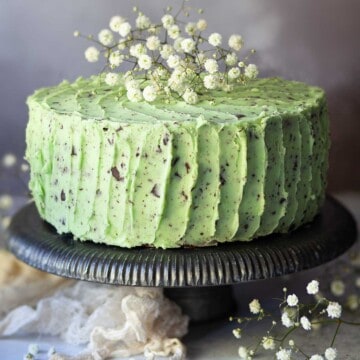 Close up of chocolate mint cake garnished with flowers.