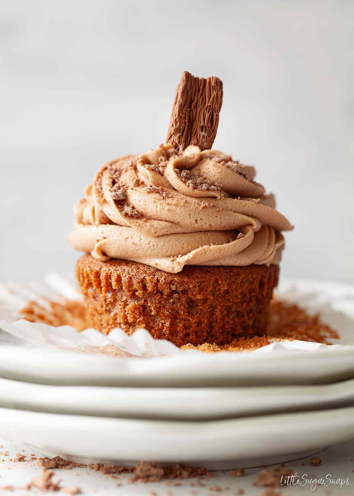 A hot chocolate themed cupcake with a Cadbury Flake bar wedged in the buttercream.