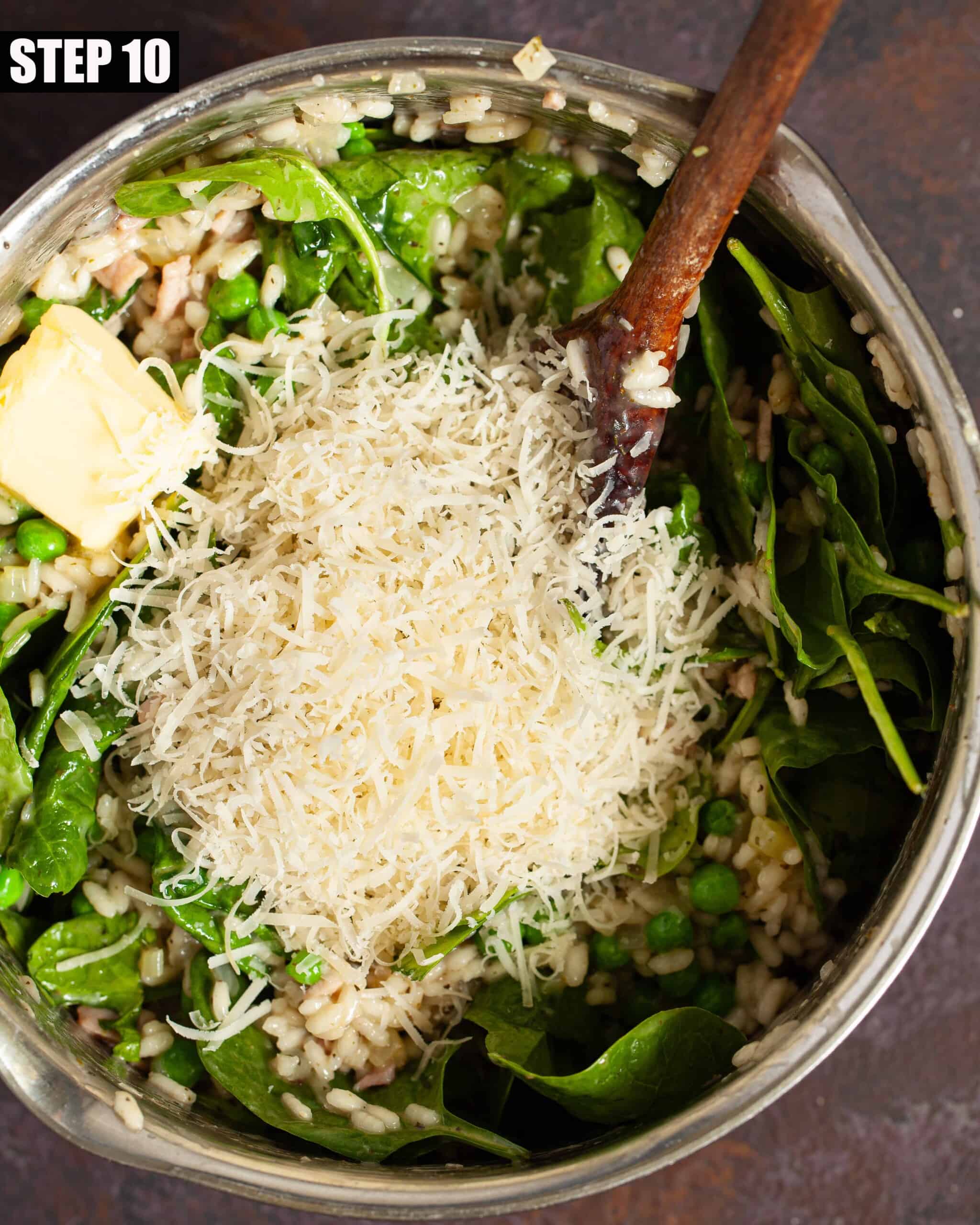 Spinach, butter and grated parmesan cheese being stirred into cooked rice.