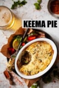 Single portion keema pie with a side salad and beer. With text overlay.