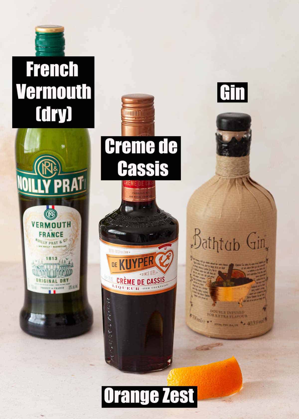 Labelled ingredients for a Creme De Cassis cocktail with gin and French vermouth.