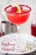 Raspberry margarita with freeze dried raspberry and lime garnish with text overlay.