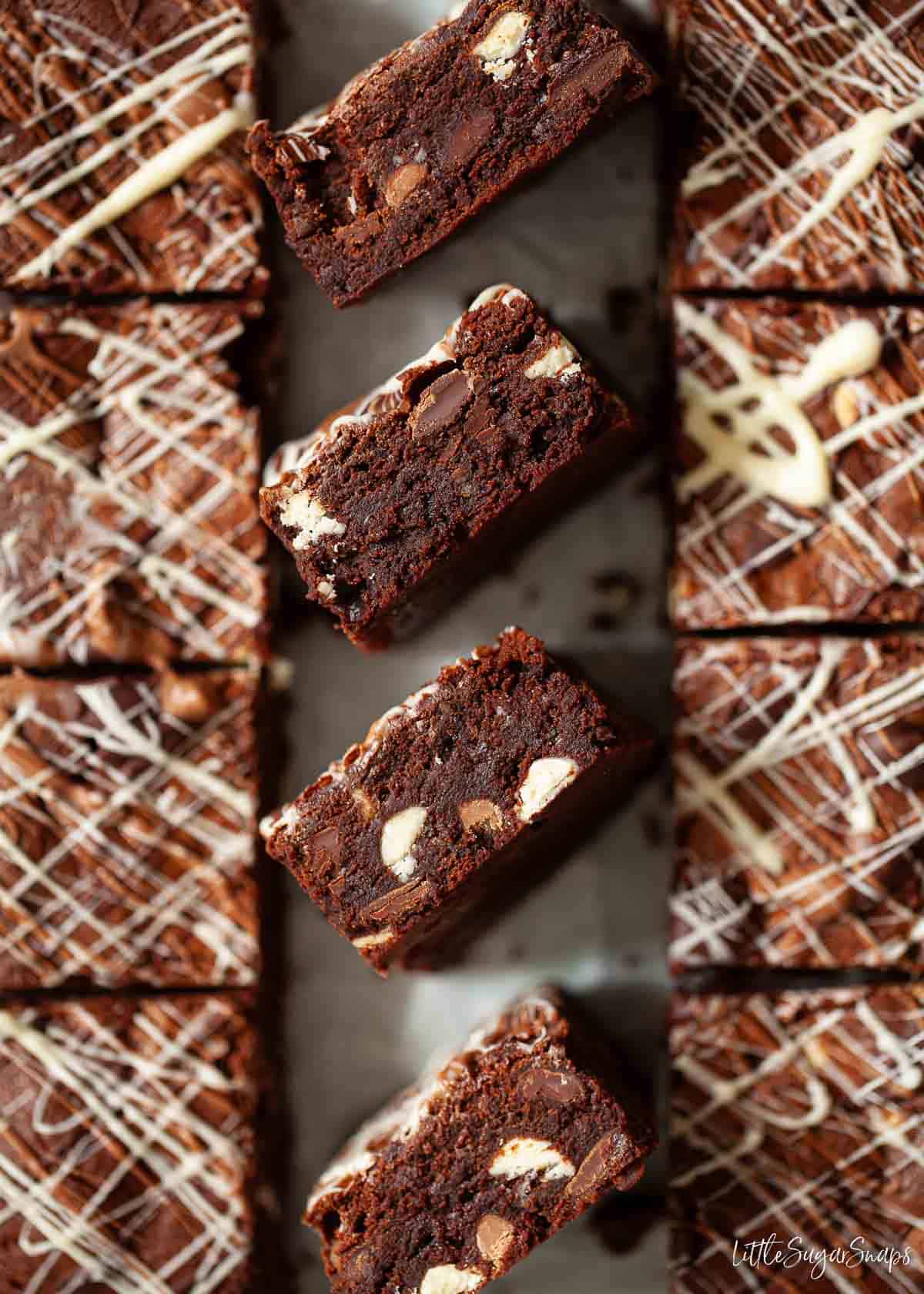 Mixed chocolate brownies with pieces on their side to show chocolate chips baked into them.