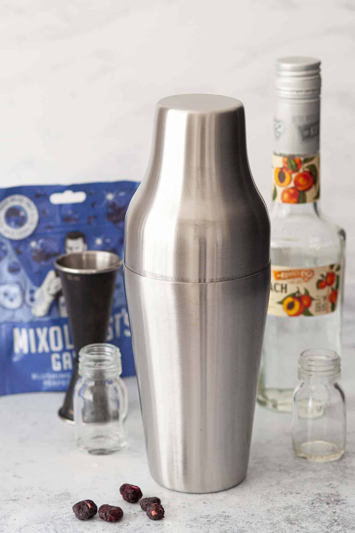 A cocktail shaker with the lid secured ready for shaking.