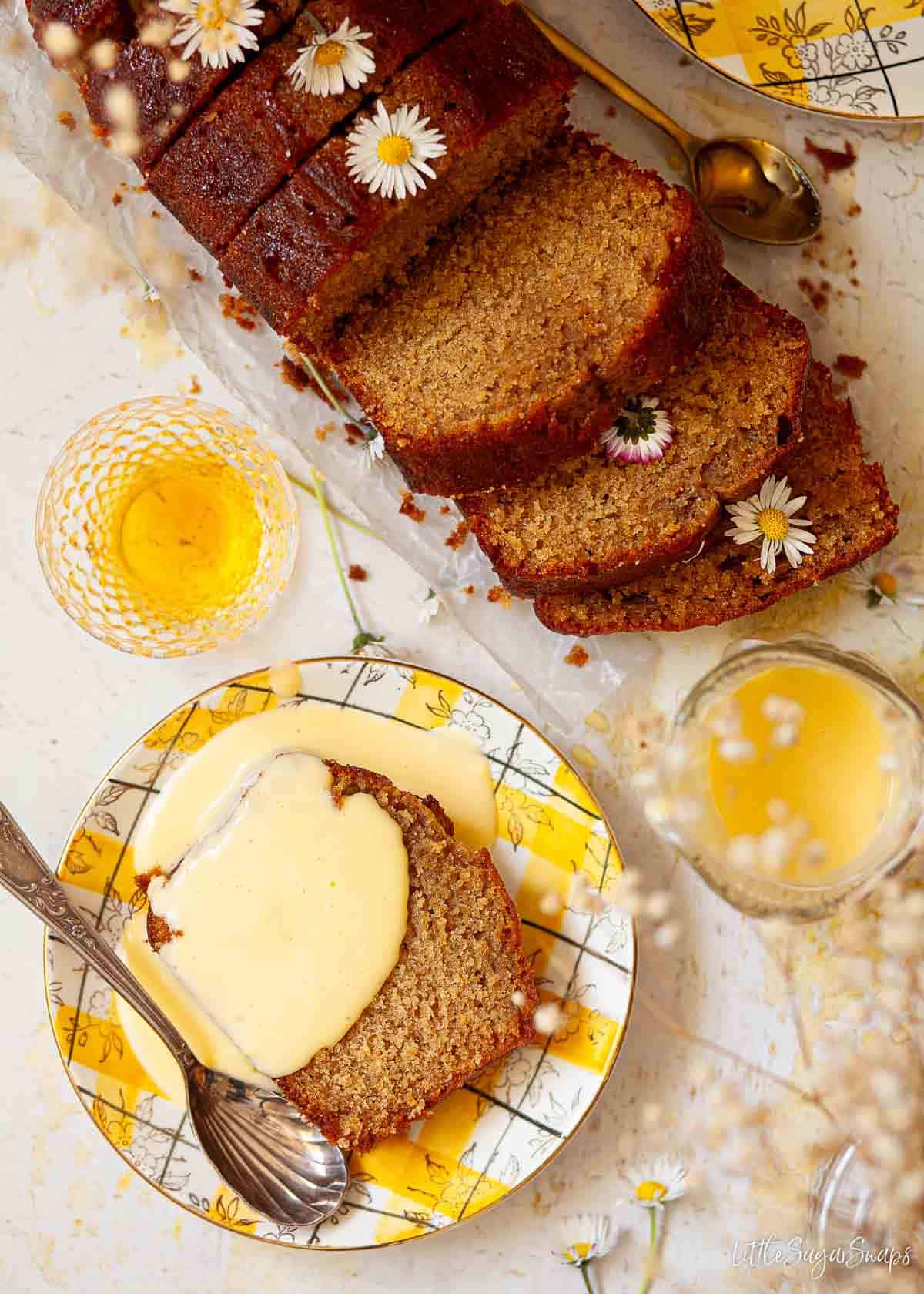 A slice of golden syrup cake with custard poured over the top of it.