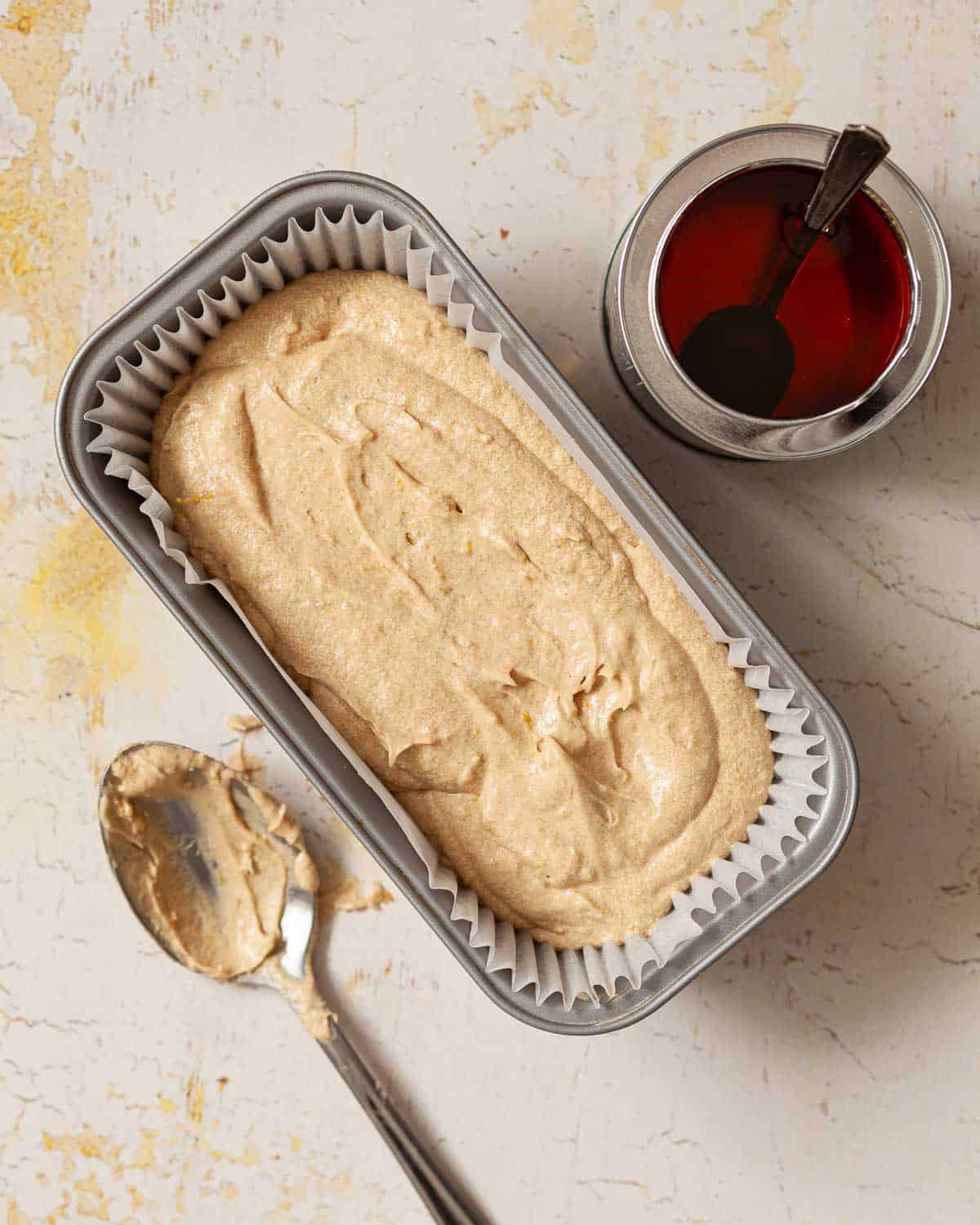 Cake batter inside of a loaf tin ready to be baked.