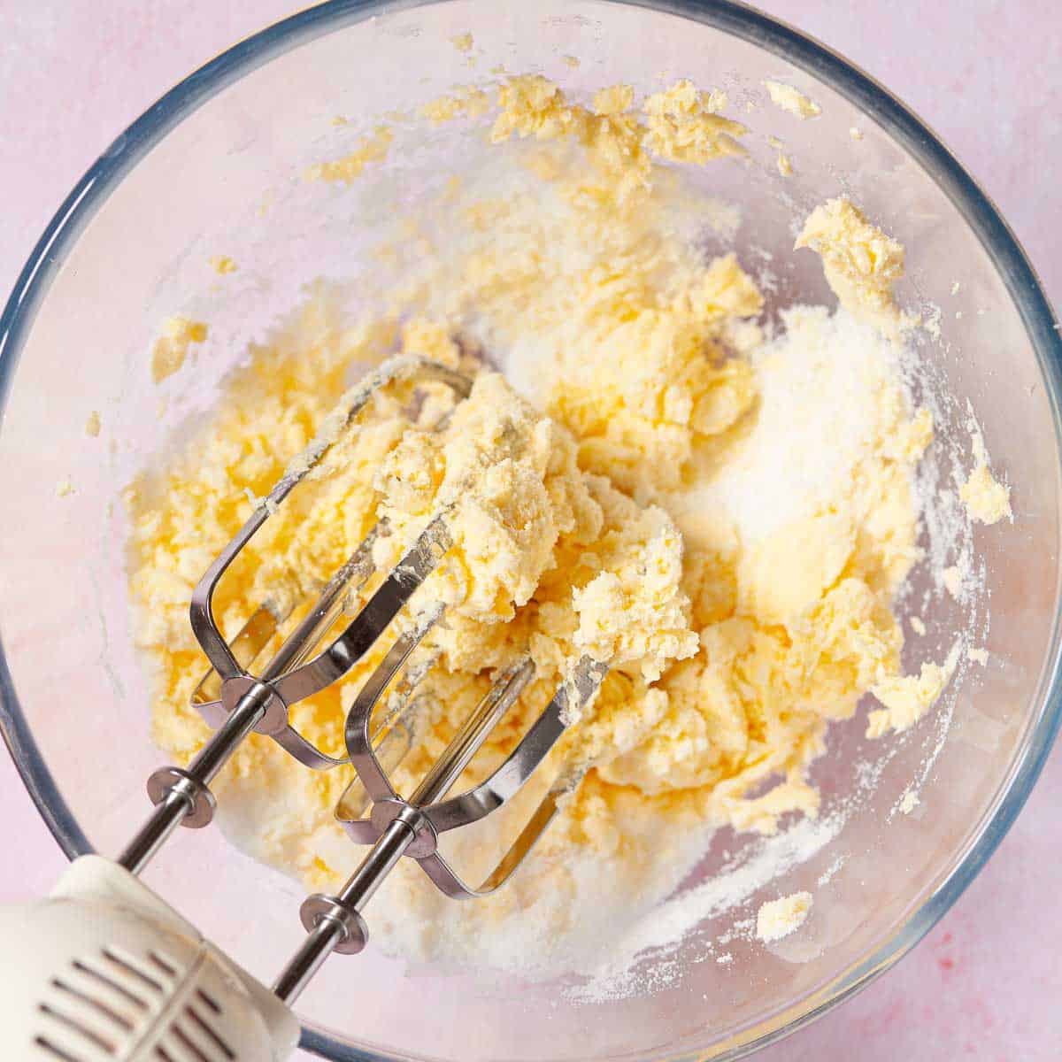 Butter and sugar being creamed together with electric beater.