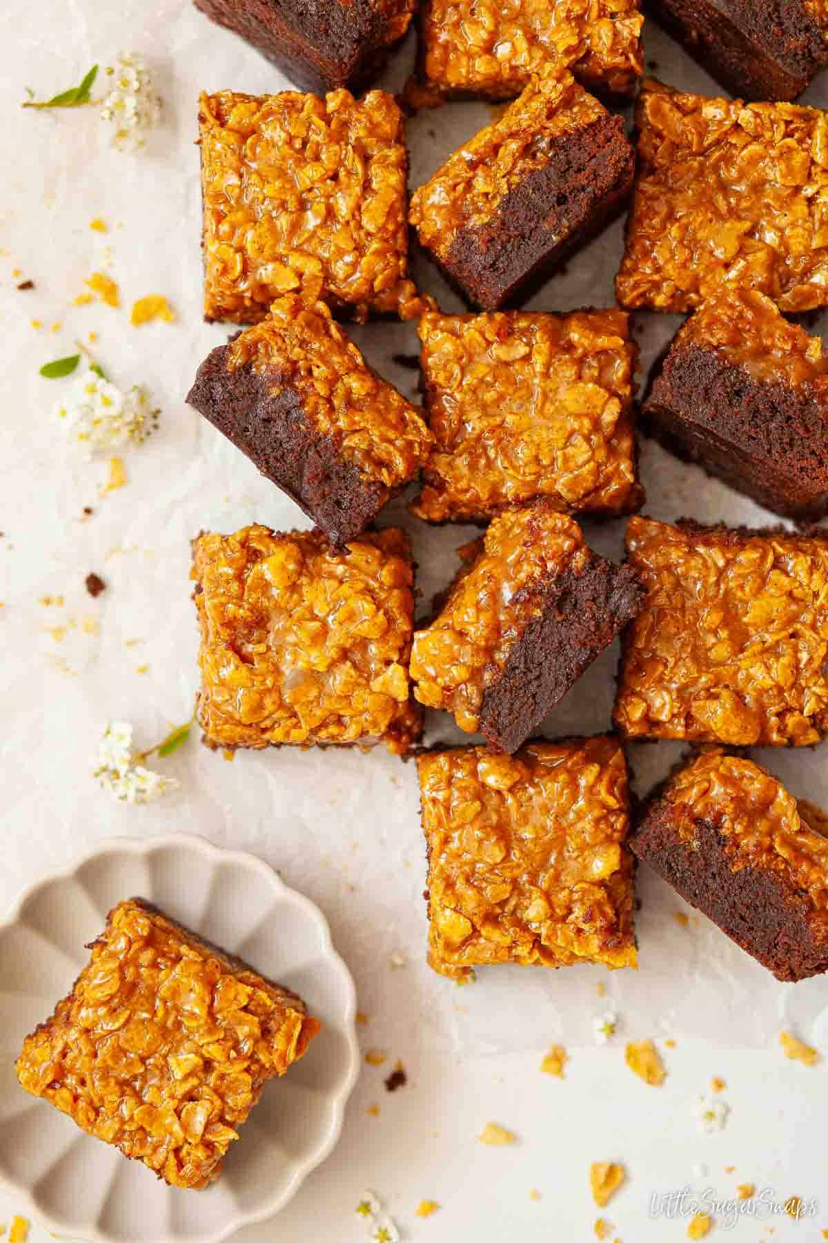 Caramel cornflake brownie squares with a few on their side to reveal the layers.