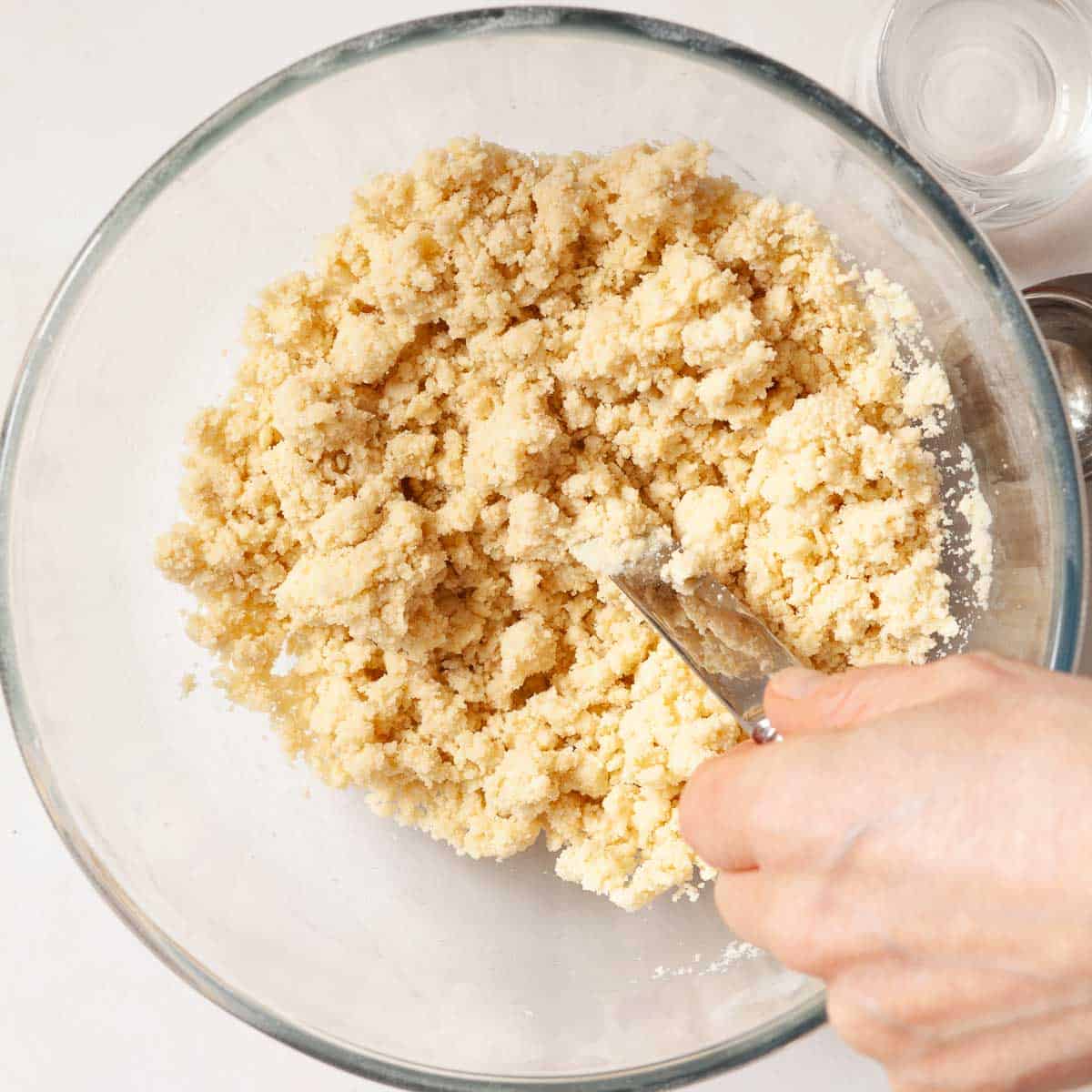 A person mixing water into pastry mix.