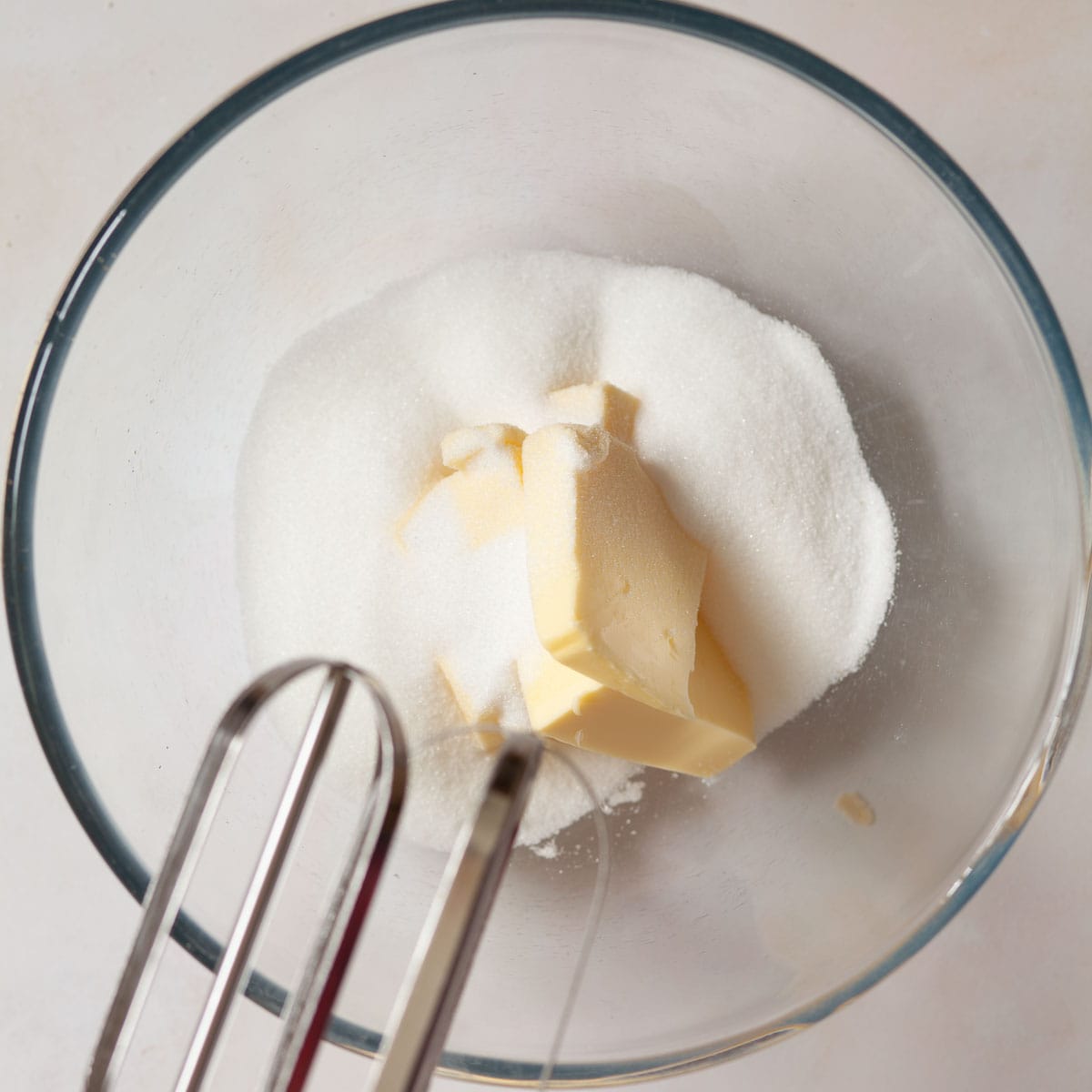 Butter and sugar in a mixing bowl.