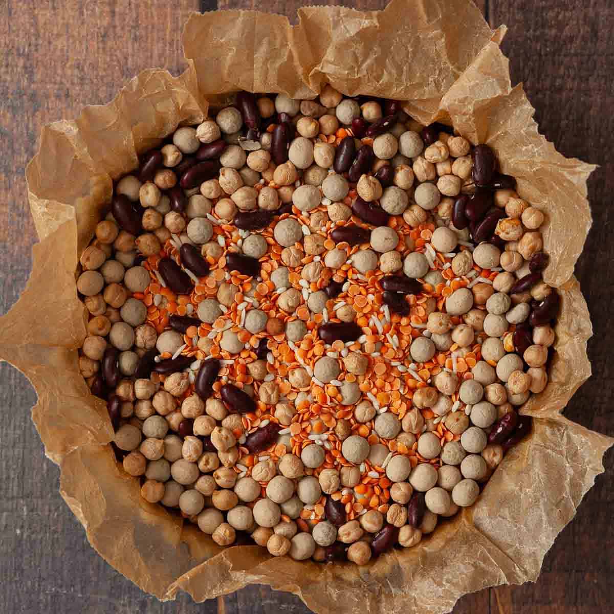 Baking parchment and baking beans & dried pulses in a tart case for blind baking a pastry case.