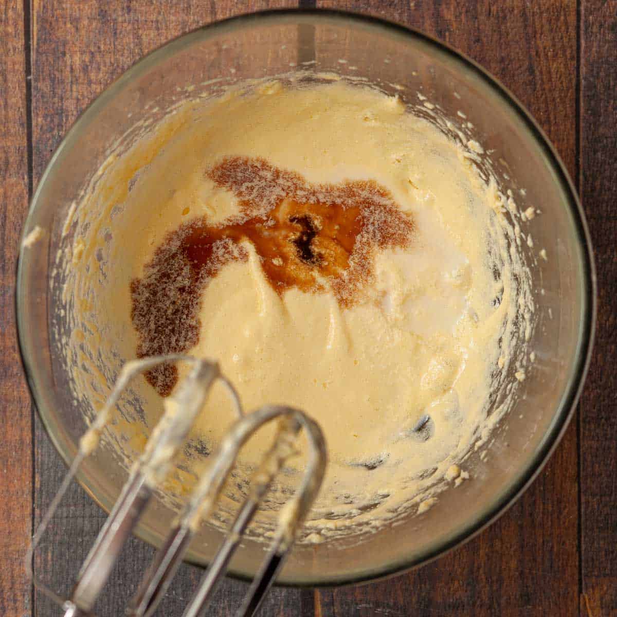 Sponge cake batter with vanilla extract and milk about to be mixed in.