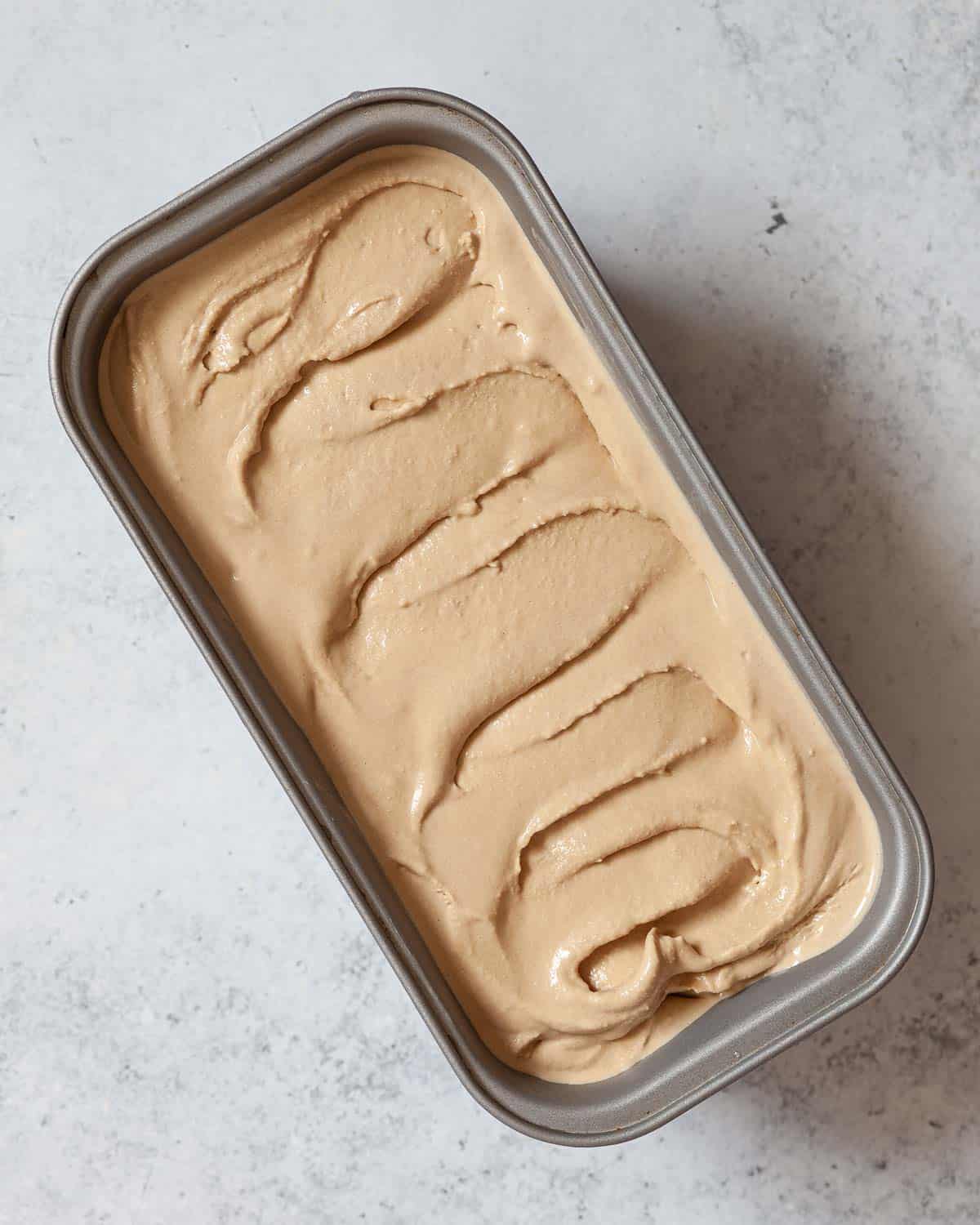 Coffee flavoured ice cream in a metal container.