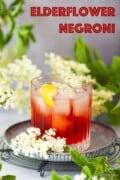 A negroni variation made elderflower liqueur and gin and garnished with lemon and elderflowers.