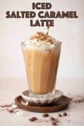 Labelled iced salted caramel latte drink with whipped cream, chocolate flakes and a straw.
