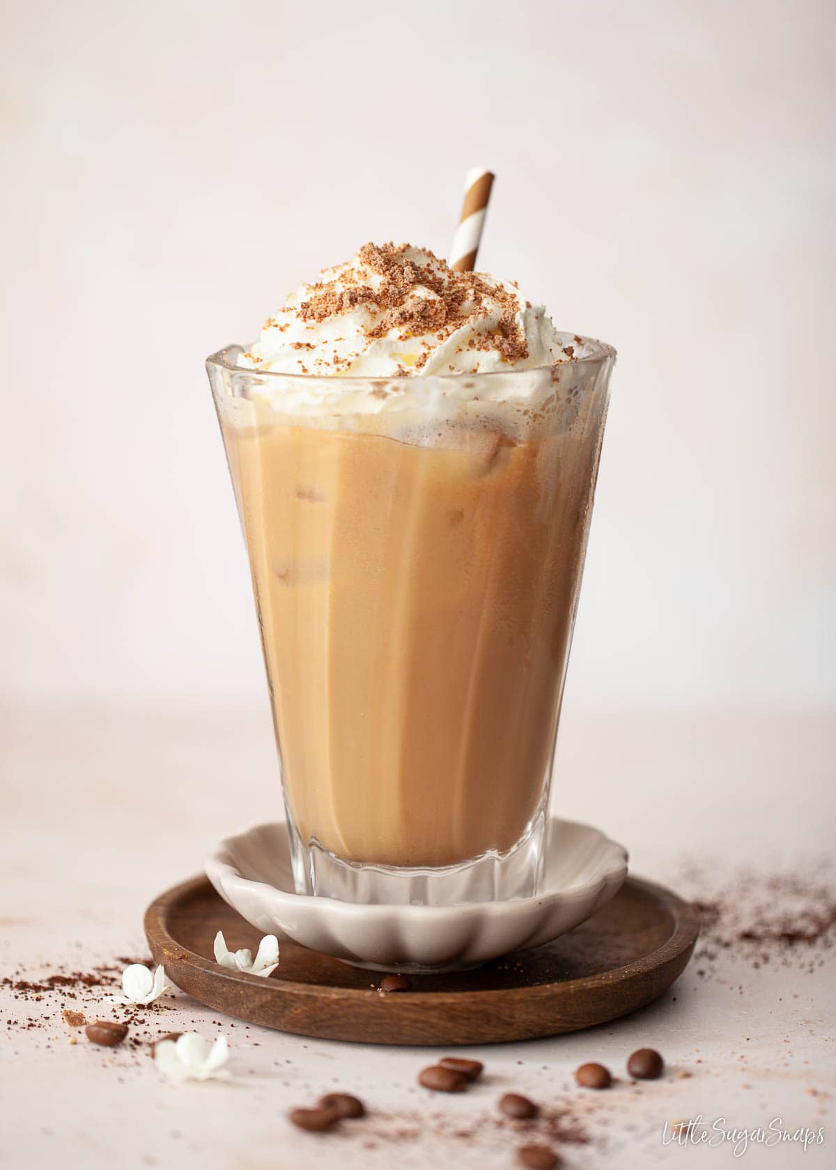 An iced salted caramel latte topped with cream ad flaked chocolate.
