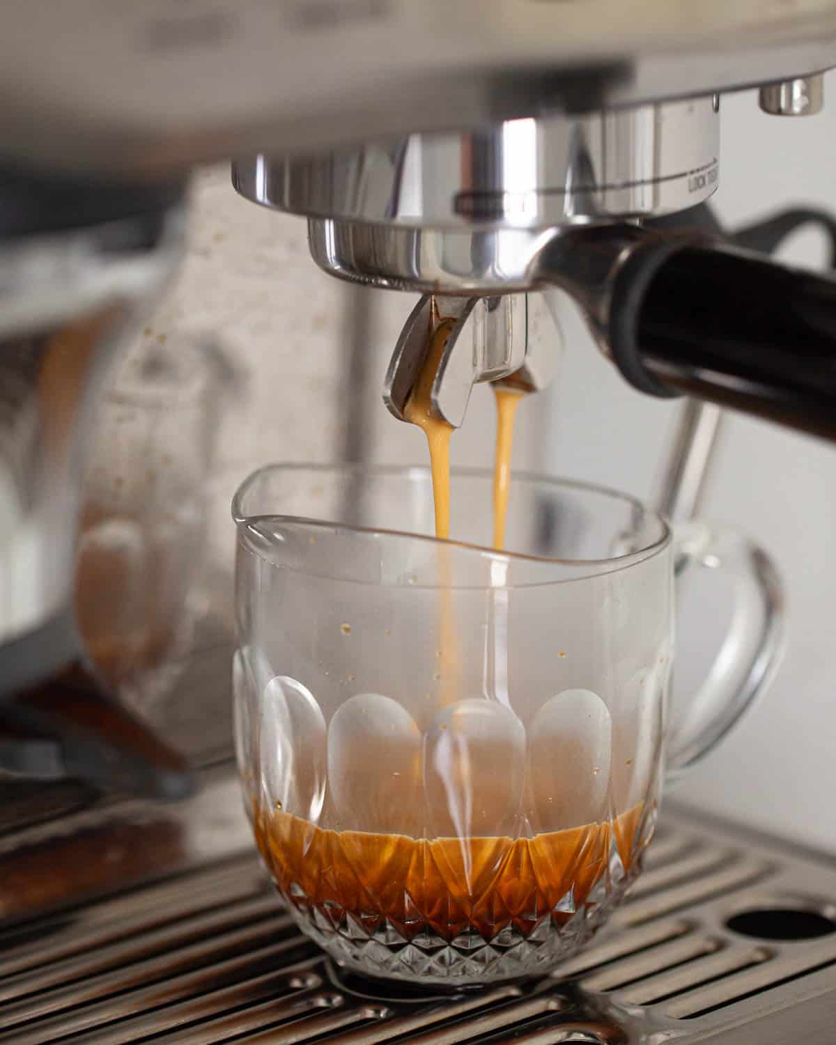 Espresso coffee being pulled from an espresso coffee machine.