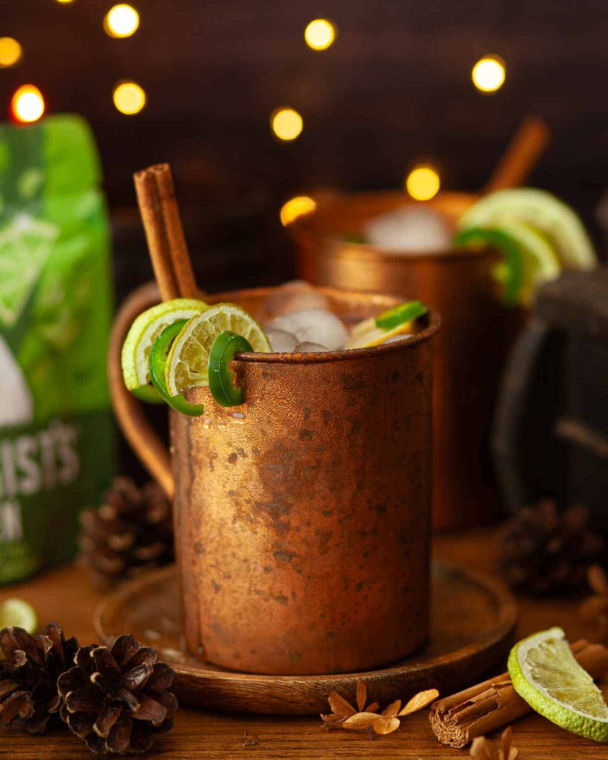 Garnishes added to a cocktail in a copper mug.