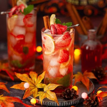 Red strawberry flavoured mojito cocktails in an autumnal setting.