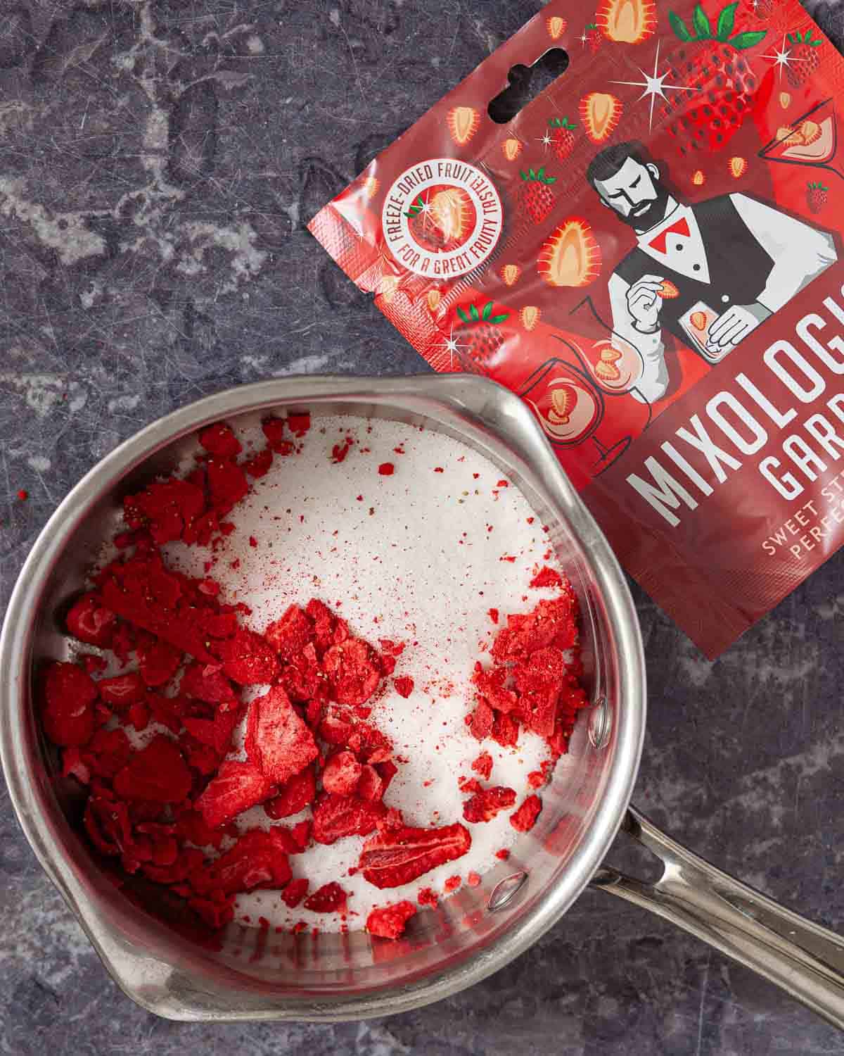 Ingredients for strawberry cocktail syrup in a small saucepan.